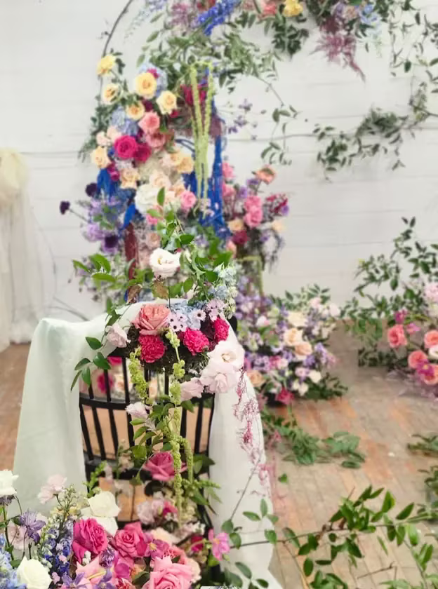 Ceremony chair installation draped in pastel florals