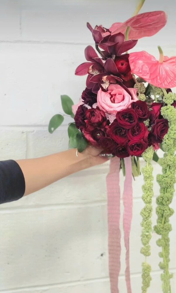 Cascading bridal bouquet with orchids and trailing amaranthus