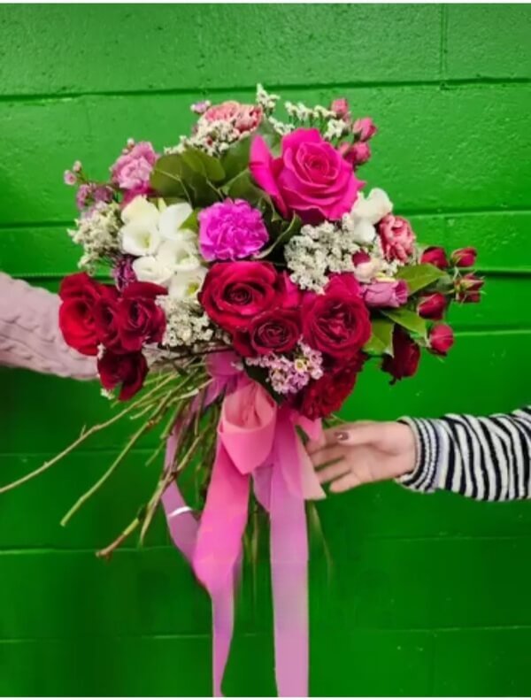 Vibrant spiralled bouquet with pink ribbon