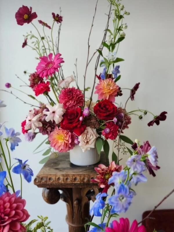 Garden style floral design on antique stand