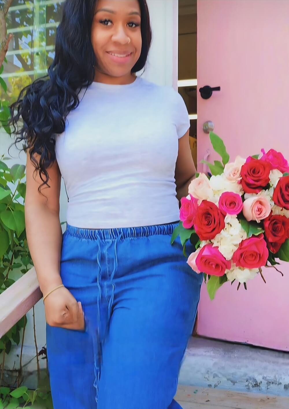 Student with a hand-tied bouquet of roses